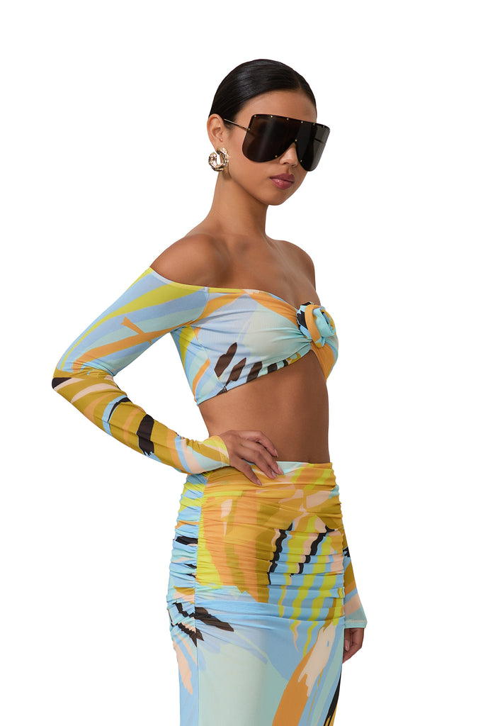 women's crop top with a plunging neck with a front ruched detail and a rose in bird of paradise print